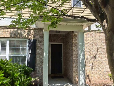 Doorway to property featuring brick siding