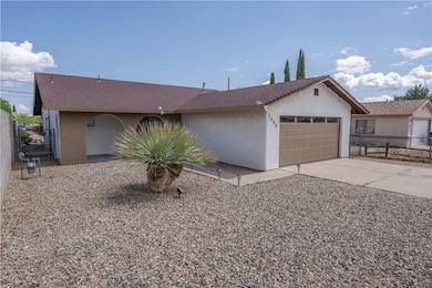 Ranch-style house with a garage, driveway, and stu
