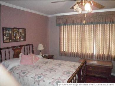 Spacious upstairs bedroom has views from big windo