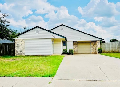 View of front facade featuring stone siding, concrete driveway, and an attached garage