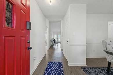 Entrance foyer with a textured ceiling, wood finis