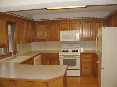 Space saver kitchen with gas range, new microwave, wood flooring and pantry.