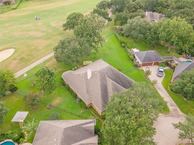 The oversized backyard offers open green space shaded by mature trees, with serene golf course views and plenty of room to run, garden, or unwind.