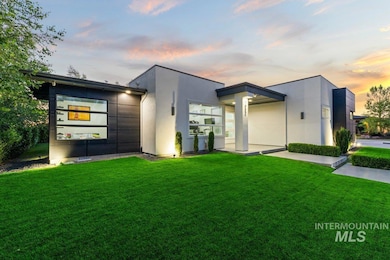 Contemporary home with a front yard and stucco siding