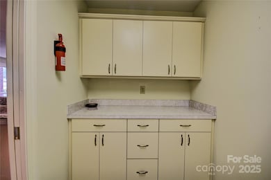 Cabinets in the laundry room adjacent to the kitchen