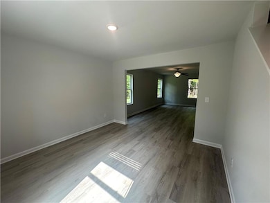 Unfurnished room with baseboards, ceiling fan, and