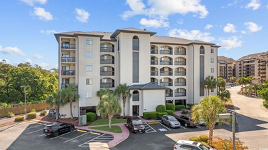View of apartment building / complex with uncovered parking and fence