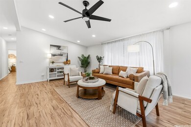 Spacious living room with a view of the hallway to the bedrooms and baths.