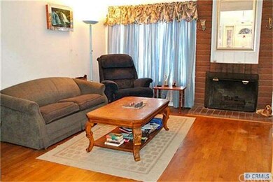 Spacious living room has a brick fireplace.