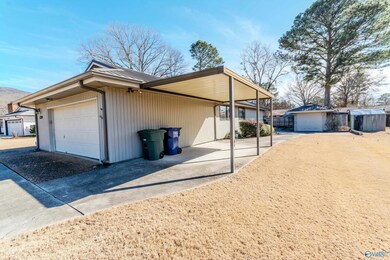 ATTACHED GARAGE, DETACHED GARAGE PLUS WORKHOP AND ANOTHER CARPORT BEHIND GATE.