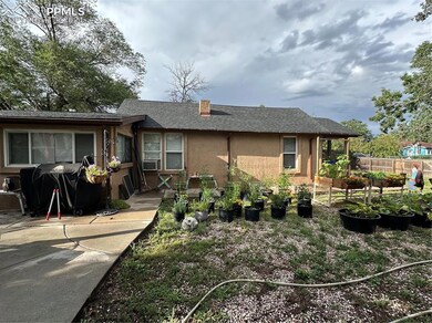 View of side of home, fenced front yard and shaded
