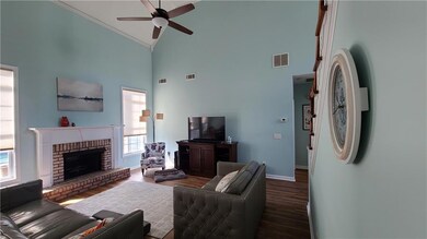 Living area with wood finished floors, baseboards,