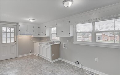 This freshly painted kitchen boasts Brand new base cabinetry, countertops and flooring.