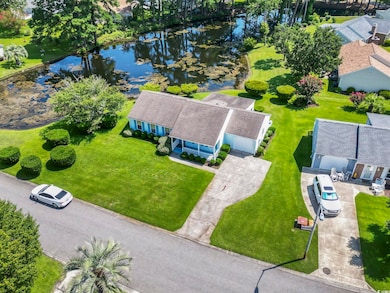Aerial view of property and surrounding area with a nearby body of water