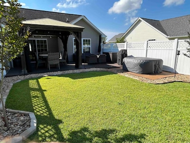 Rear view of house featuring a gazebo, a patio area, and an outdoor hangout area