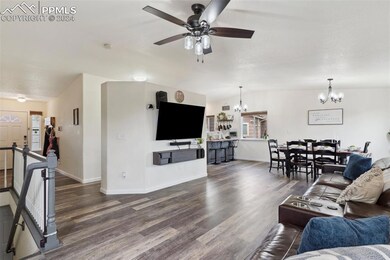 Living room featuring ceiling fan with notable cha