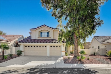 Mediterranean / spanish-style house featuring an attached garage, concrete driveway, stucco siding, a tile roof, and a gate