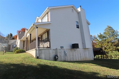 View of side of property with a lawn and a chimney