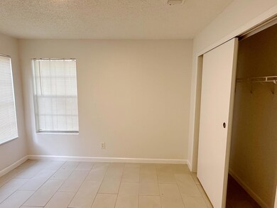 Unfurnished bedroom with a closet, a textured cei