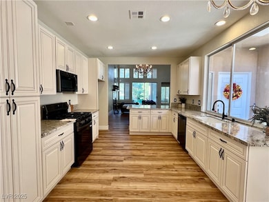 Kitchen with black stainless steel appliances, a p