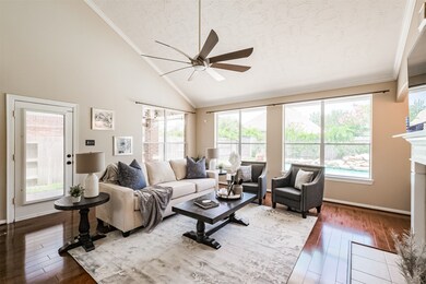 Living room close to covered patio. Wood floors. High ceilings.