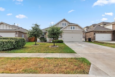 View of front of property featuring concrete driveway, a front yard, and stucco siding