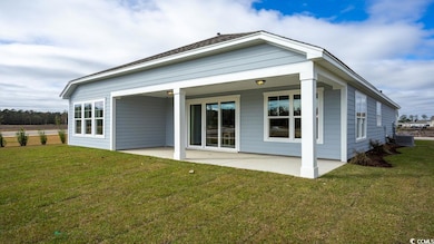 Rear view of house featuring a patio area, central AC unit, and a yard
