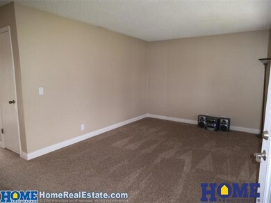 Living Room is freshly painted and has new carpet.