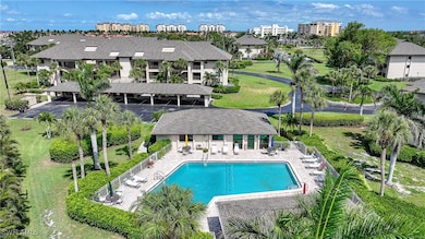 Back of house featuring a community pool and a pat