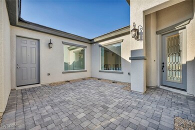 Property entrance with a patio area and stucco sid