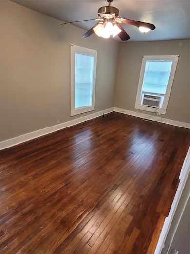 Empty room featuring dark wood-style flooring, ce