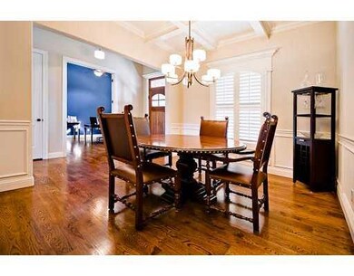 Dining Room. Coffered ceiling, plantation shutters, bar with beverage refrigerator, wide plank hardwood floors.