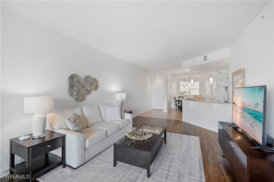 Living room with hardwood / wood-style flooring an