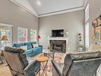 Carpeted living room featuring ornamental molding,