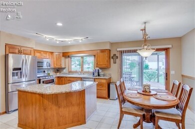Open kitchen with a lot of granite counter space walks out onto the covered deck.
