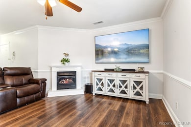 Living area with visible vents, dark wood-style fl