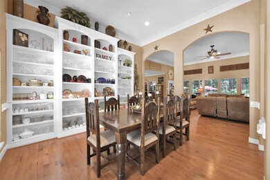 The dining room features built-in shelving for showcasing items or storage purposes.