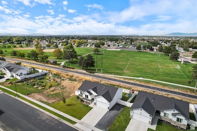 Aerial perspective of suburban area featuring a mountain backdrop