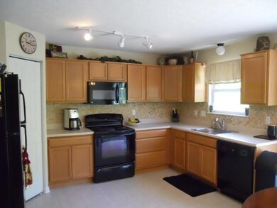 Spacious, fully equipped kitchen with backsplash t