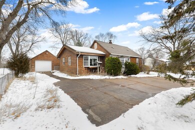 Front view of how, driveway, and 1-stall garage.