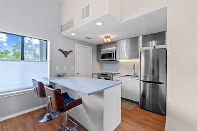 Kitchen with stainless steel appliances, a sink, 