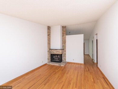 Gas fireplace with wood floors continuing to the k