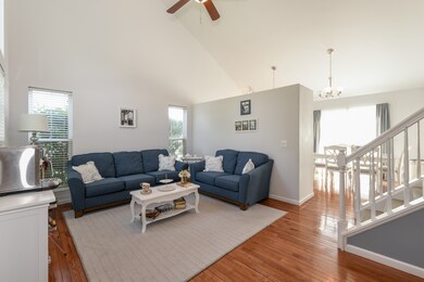 hardwood floors, vaulted ceiling and ceiling fan. 