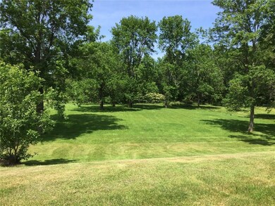 The yard to the left of the driveway can be return