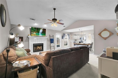 Carpeted living room with ceiling fan with notable