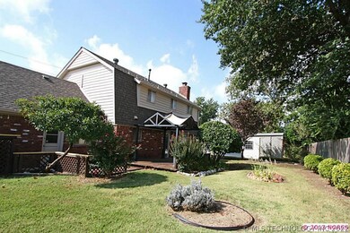 The large tranquil backyard has a deck with a perg