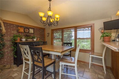 Dining area boasts vaulted ceilings and exposed br