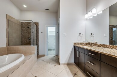 Full bath with tile patterned flooring, a stall sh