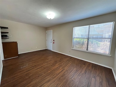 The living room is included with cabinet space and pre-existing shelving.