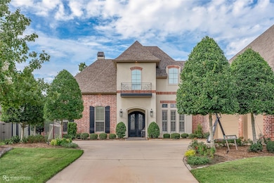French country home with a garage, a front yard, a